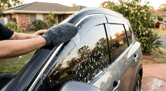 Cleaning acrylic weather shields with a microfibre cloth and pH-neutral shampoo to prevent crazing and maintain clarity in Australian conditions.