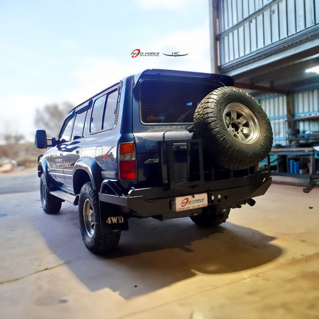 A premium-quality HIC weather shield and roof spoiler installed on a grey Toyota LandCruiser 4x4. The image highlights the seamless, factory-style fitment.