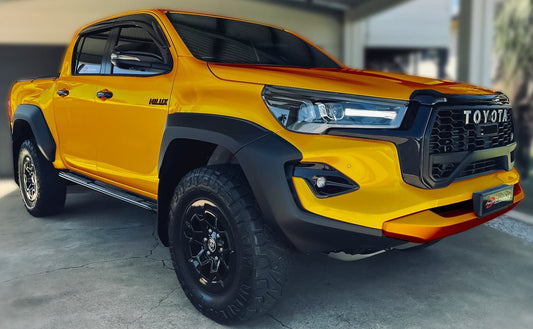 Close-up of a HIC Australia  Injection-Moulded Tinted Weather Shields flush-mounted on a Hilux’s windows, showcasing its sleek fit and UV-resistant clarity.